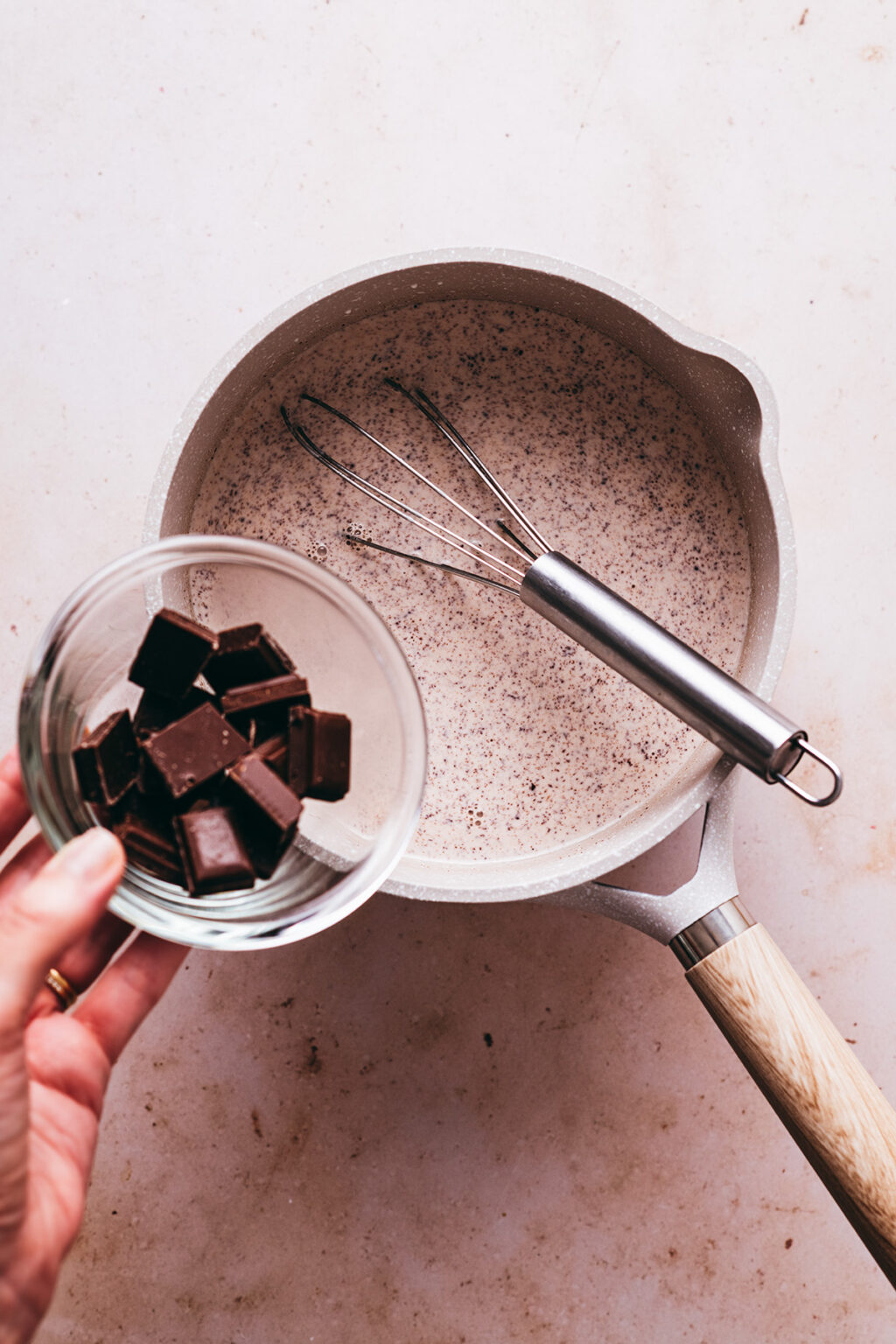 Adding chocolate cream to chocolate - Lilie Bakery